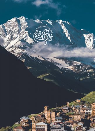 Snow-capped Mt Shkhara towering above Svan towers of Ushguli village in Svaneti, Georgia